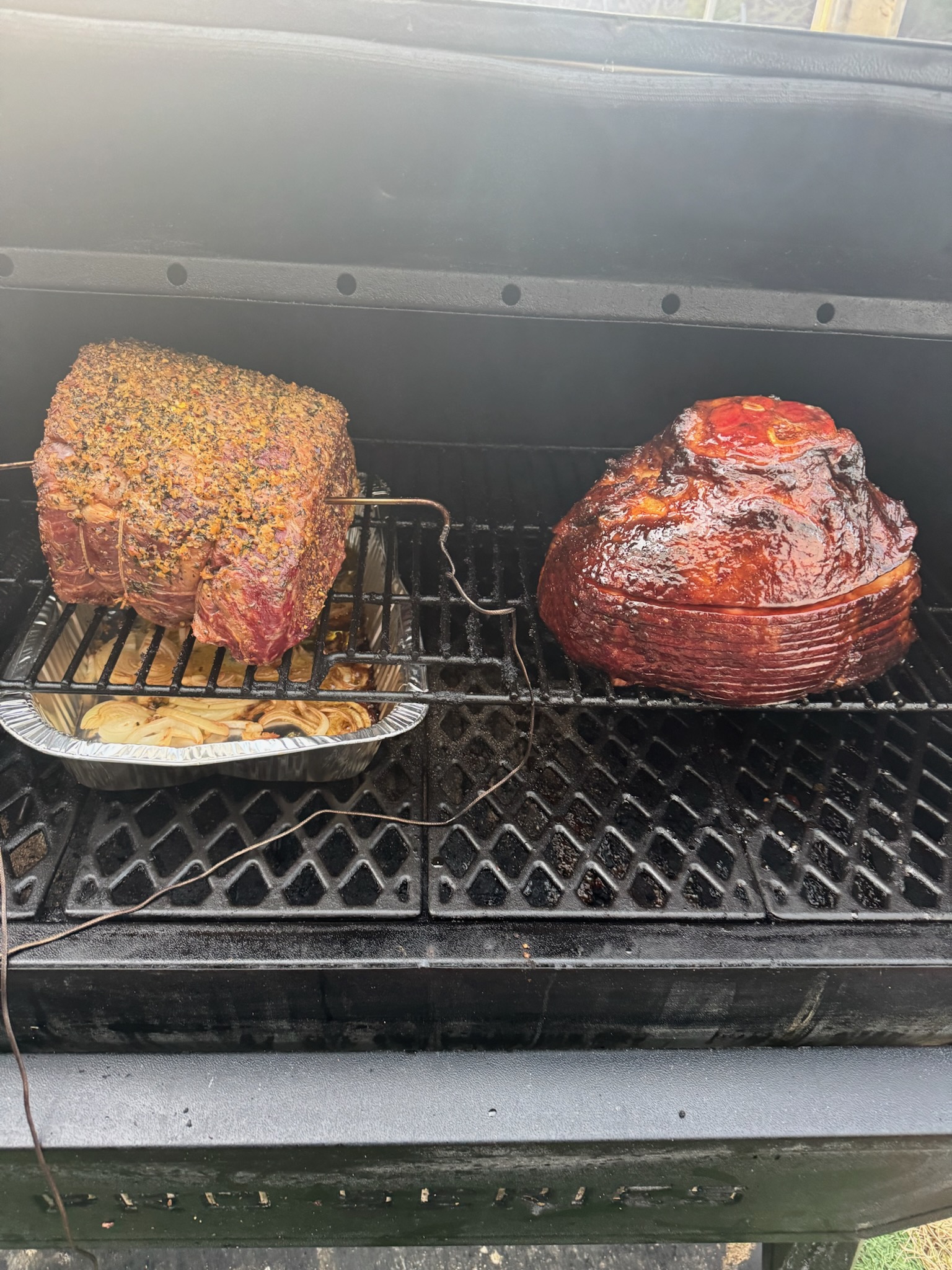 Smoked spiral glazed ham and pepper-crusted roast on the smoker